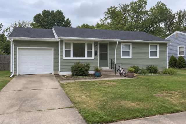 The same ranch home with sage siding